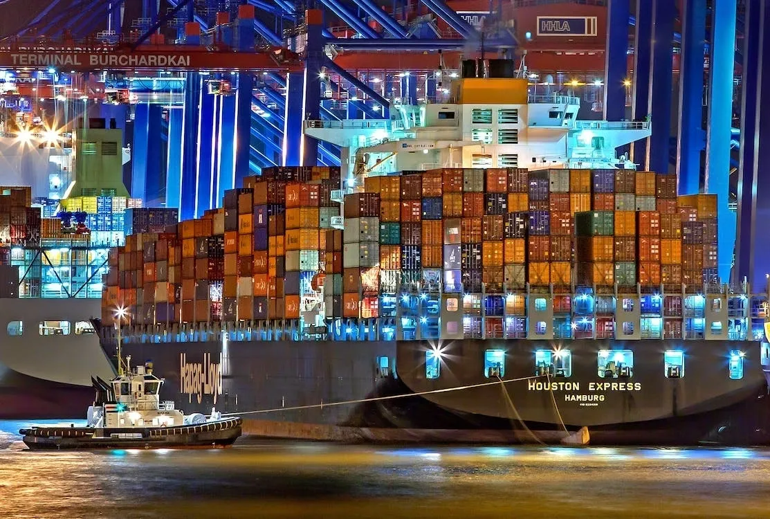 A large ship in the water at night.